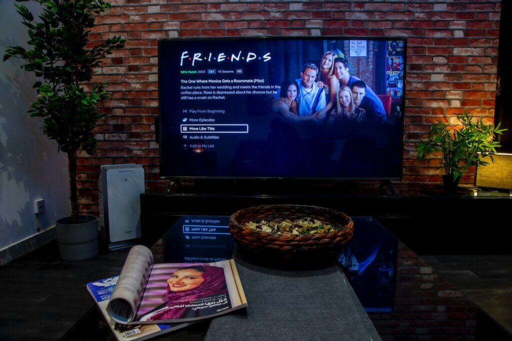 smart tv in front of brown brick wall
